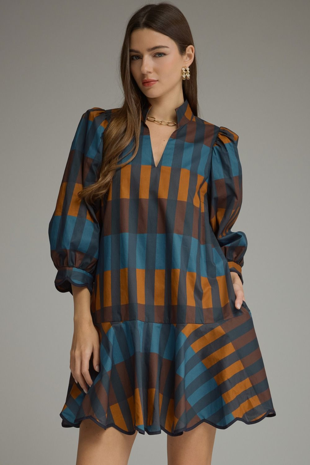 Woman wearing the Harper Plaid ¾ Balloon Sleeve Mini Dress in a blue and brown check pattern.