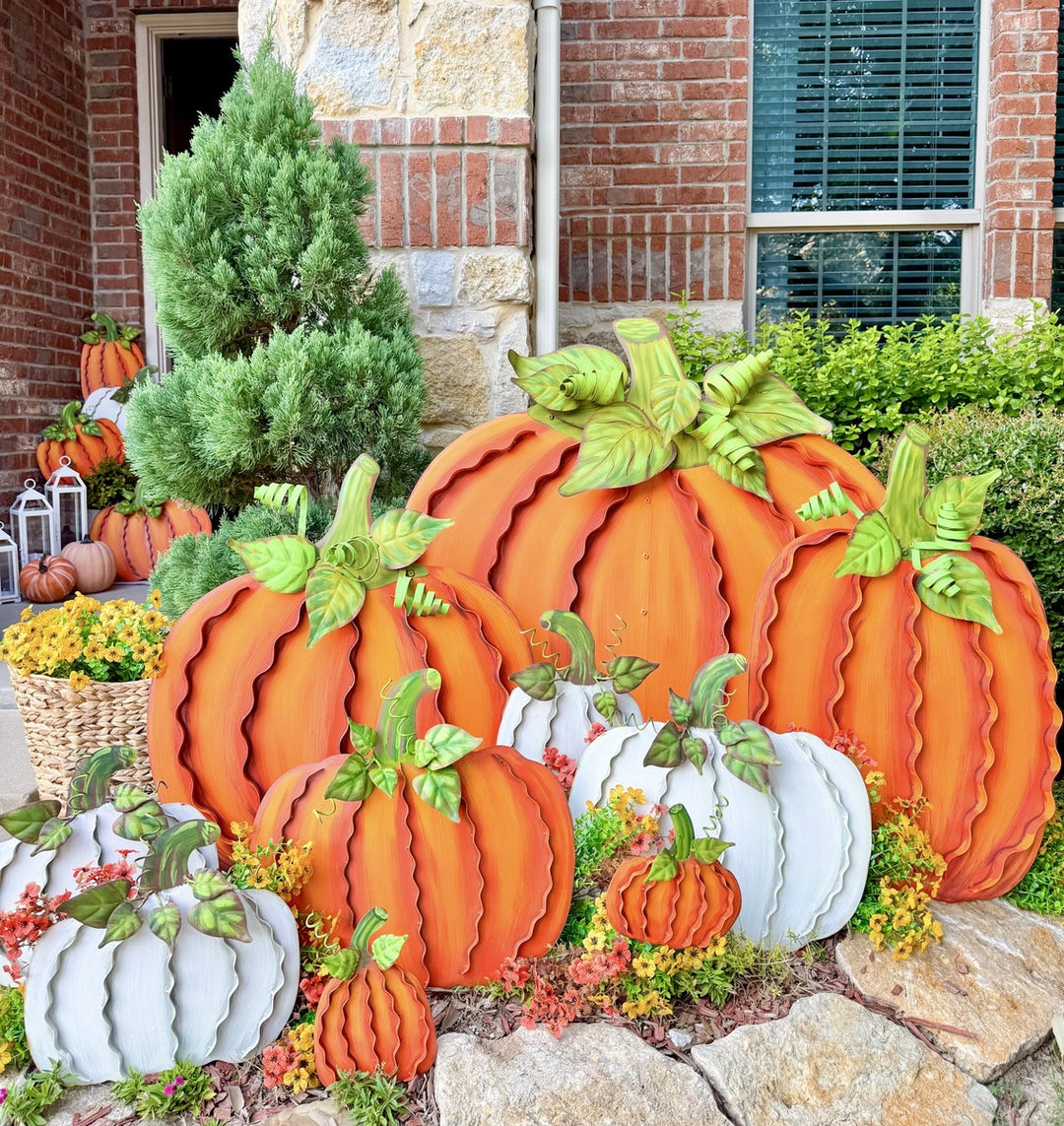 Metal ribbon pumpkin decoration in orange with a hanging loop.