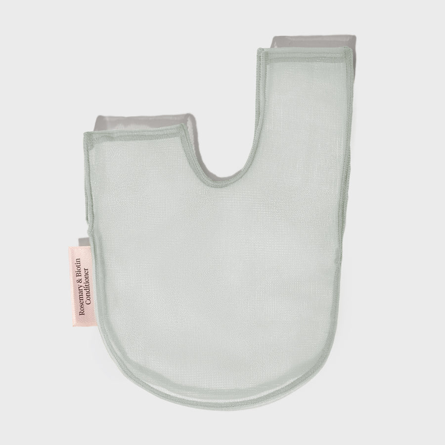 Recycled rPET mesh saver bag holding a solid conditioner bar