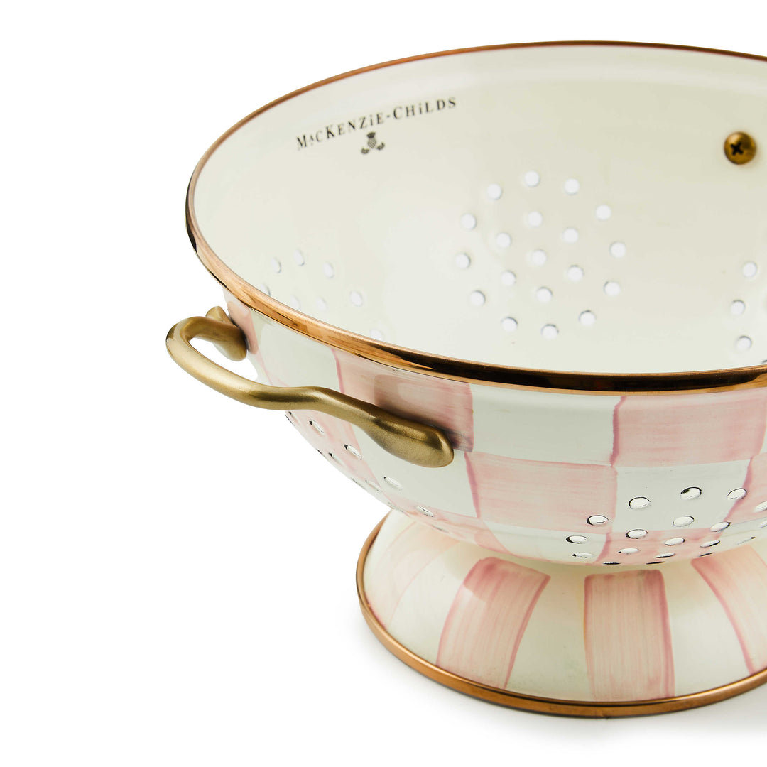 Large colander with hand-painted pink and white checks, bronzed steel rim, and brass handles.