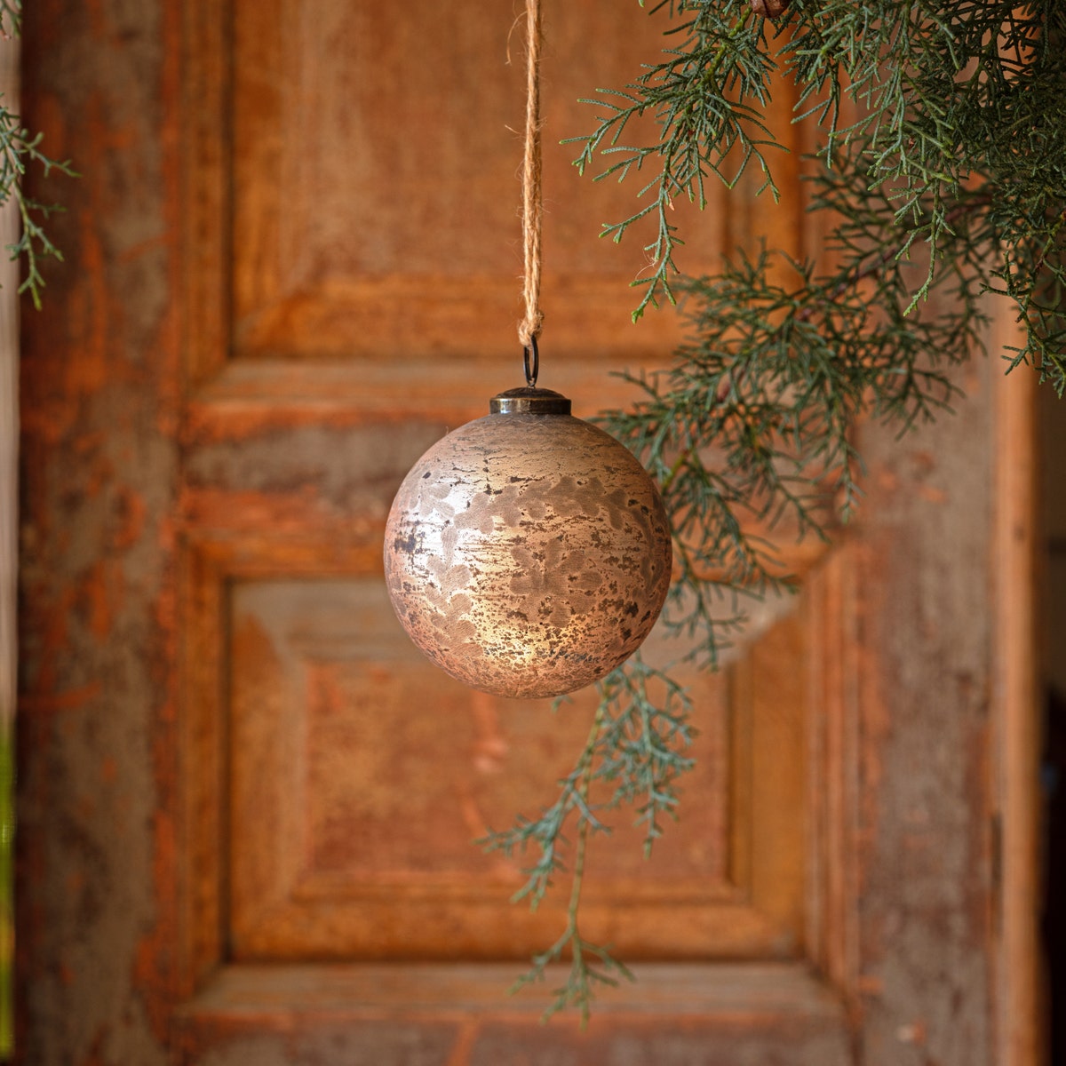 Antique foil glass etched ball ornament with a round silhouette.