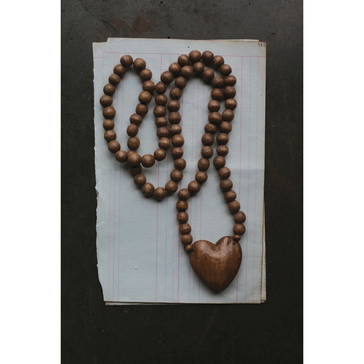 36-inch hand-carved wooden rosary featuring a heart-shaped centerpiece with natural wood grain texture.