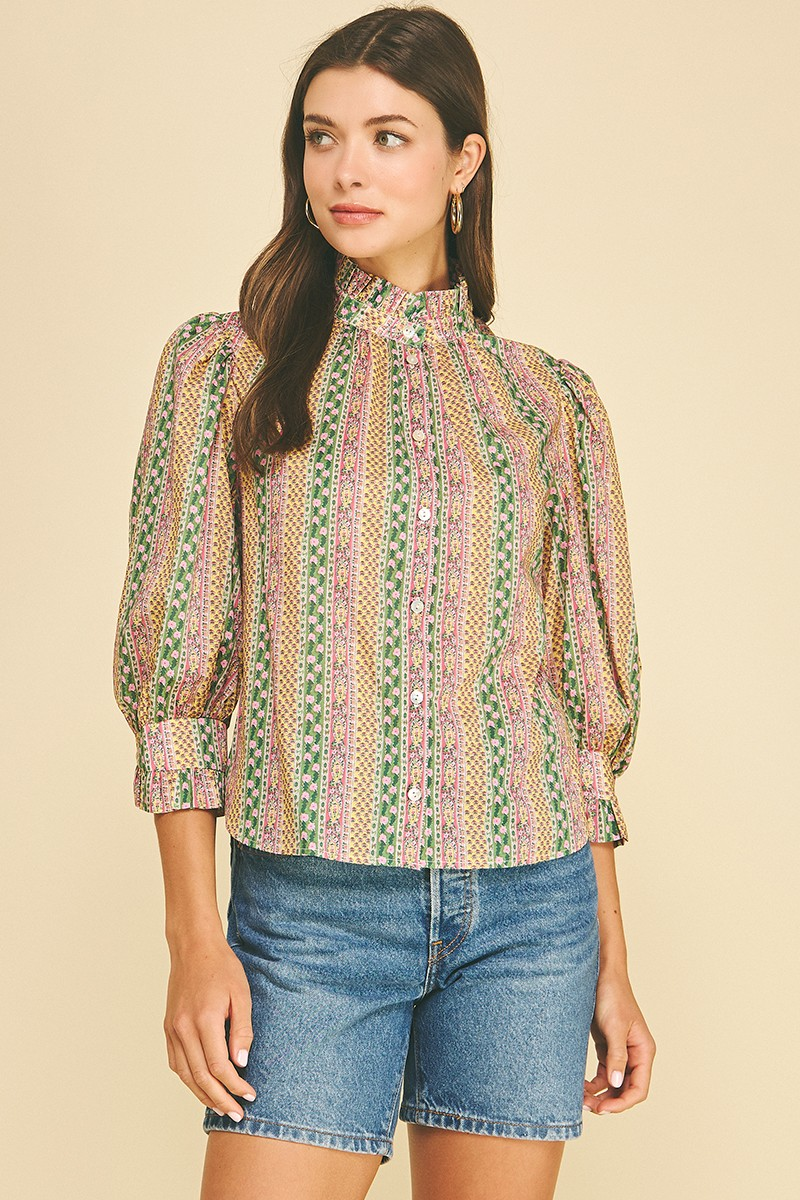 Woman wearing a Mabel floral botanical print button-down blouse with high neck and puff sleeves.