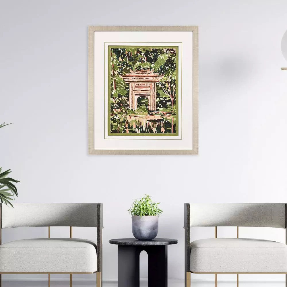 Veiled Sanctuary framed wall art featuring a pagoda in a lush green forest above two modern chairs.