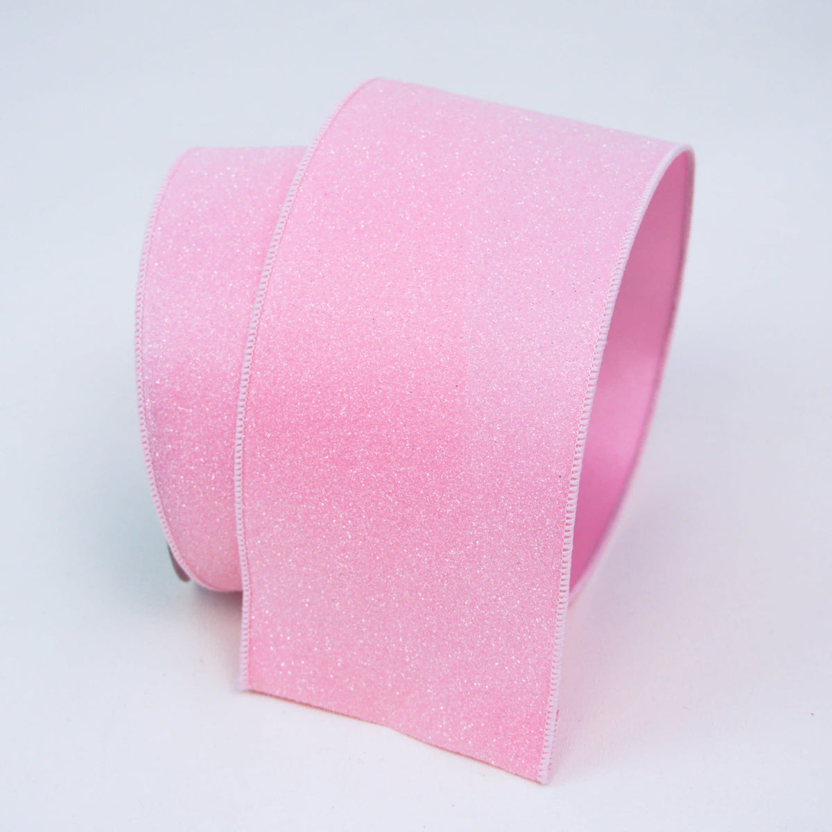 Light pink wired ribbon with a secondary fabric backing.