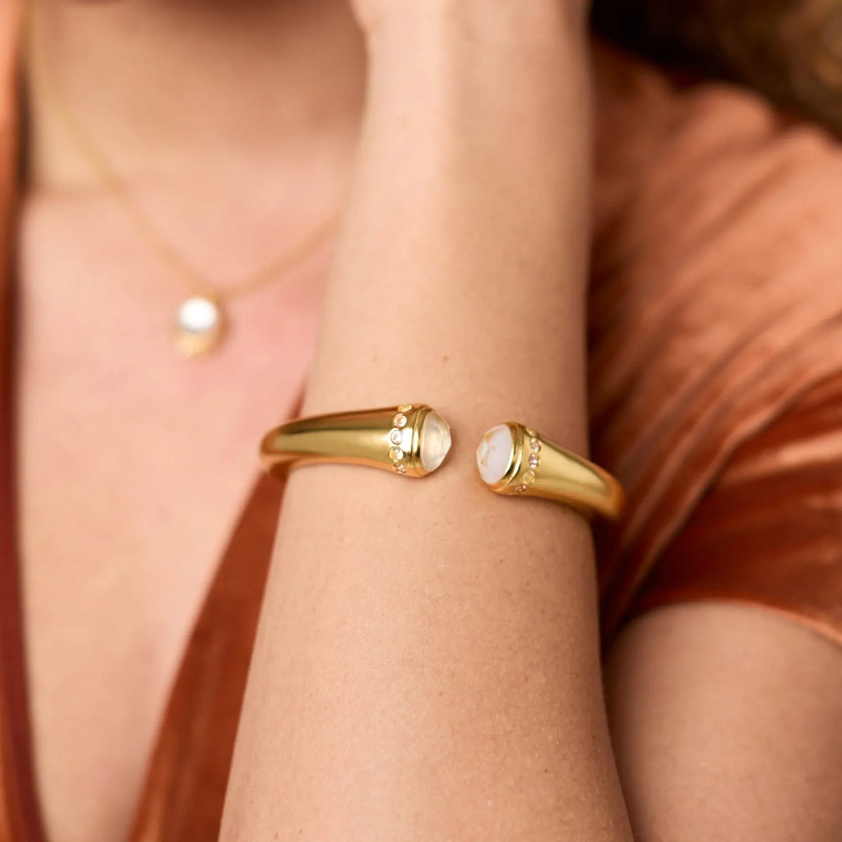 Rainbow demi cuff bracelet with imported glass stones in a vibrant multicolor pattern on gold plate.