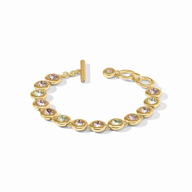 Adjustable rainbow tennis bracelet with gold plate, glass stones, CZ accents, and a toggle clasp.
