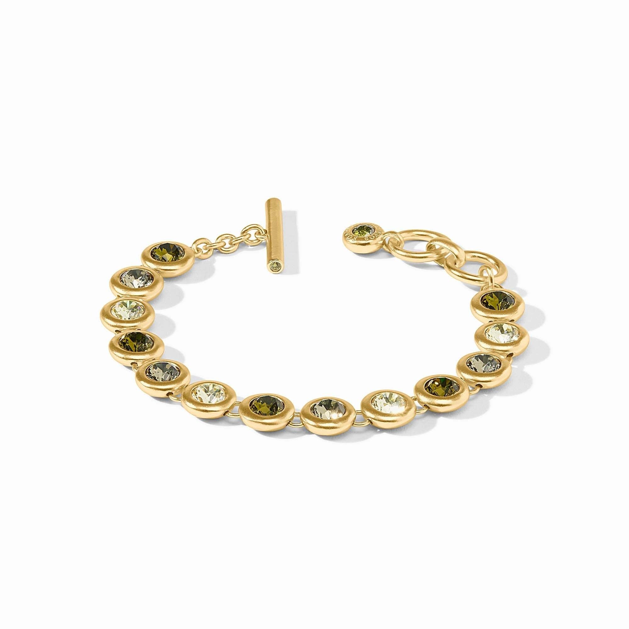 Adjustable rainbow tennis bracelet with gold plating, glass stones, and a toggle clasp.