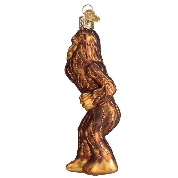 Glass Sasquatch Christmas ornament with brown glitter fur and a gold hanging loop.