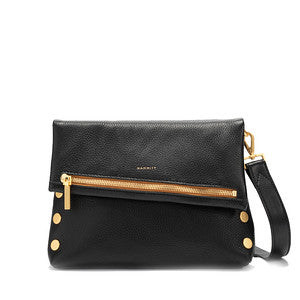 Medium zippered bag in buttery black leather with brushed gold rivets, optional strap, and red accent along the back seam.