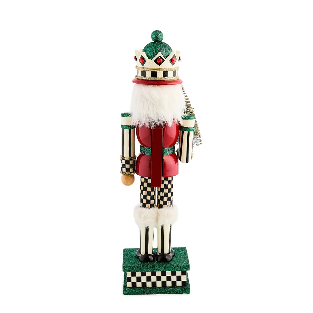 Sisal Tree Nutcracker with a red coat, checkered pants, and a green glittered crown and base.