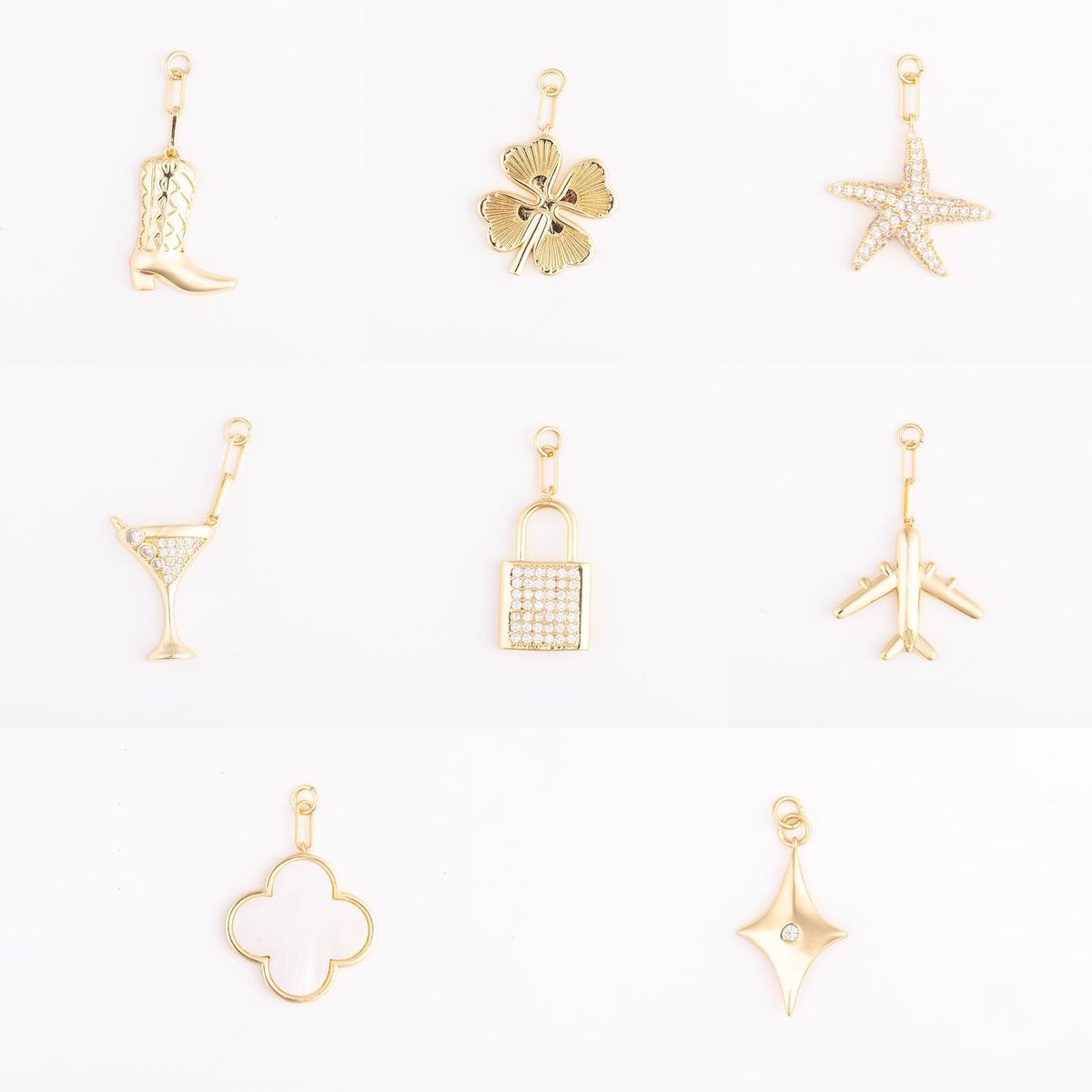 Collection of eight 18k gold-plated brass bag charms in various shapes on a white background.