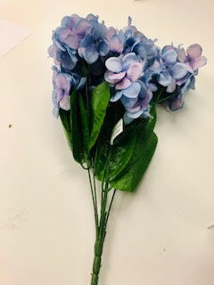 Hydrangea bush with blue and purple flowers in a potted plant silhouette.