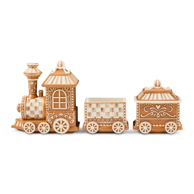 Three-piece mocha check gingerbread train centerpiece with white icing-style decorative details.