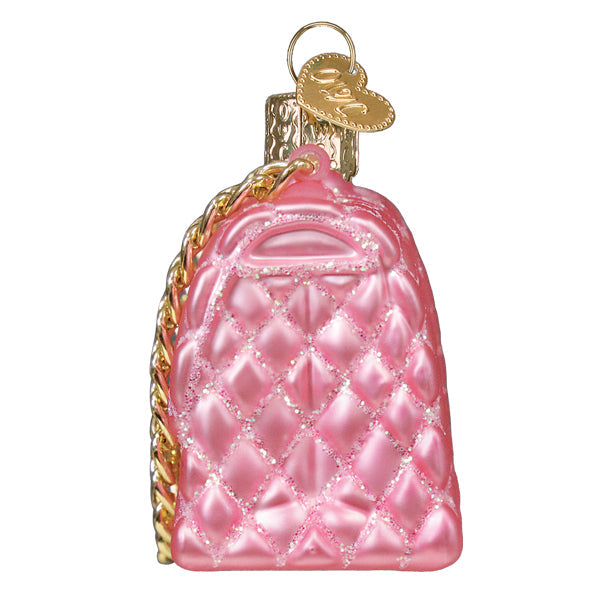 Pink quilted purse glass Christmas ornament with gold chain strap and heart charm.