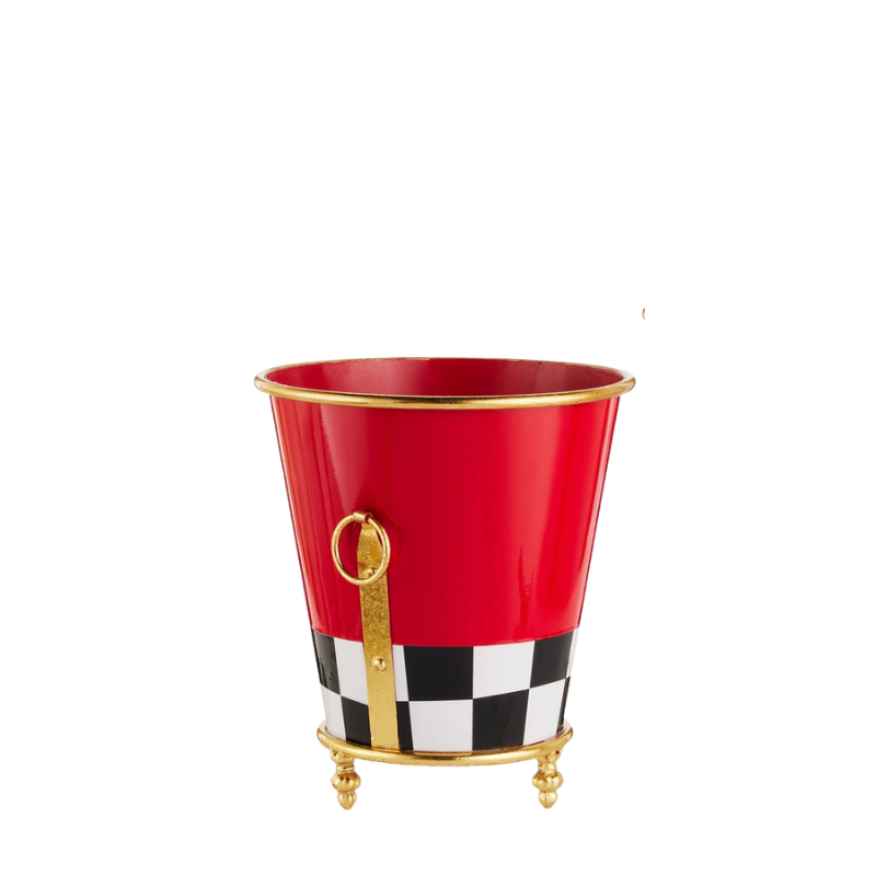 Red metal footed planter with a black and white checkered base and gold ring handles.