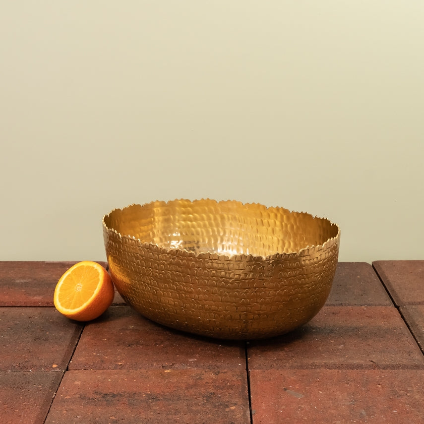 Oval hammered aluminum bowl with a gold finish