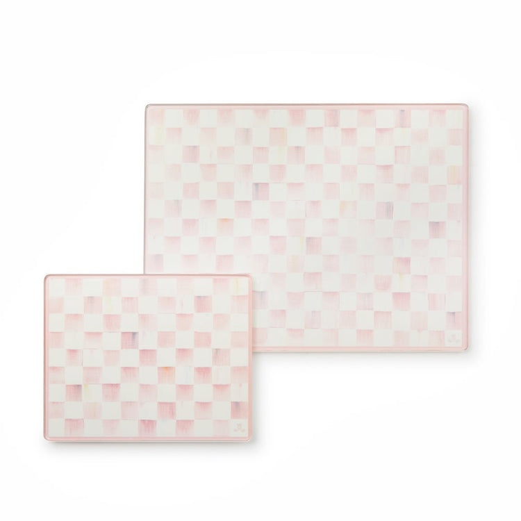 Set of two tempered glass cutting boards with a pink and white rosy check pattern.