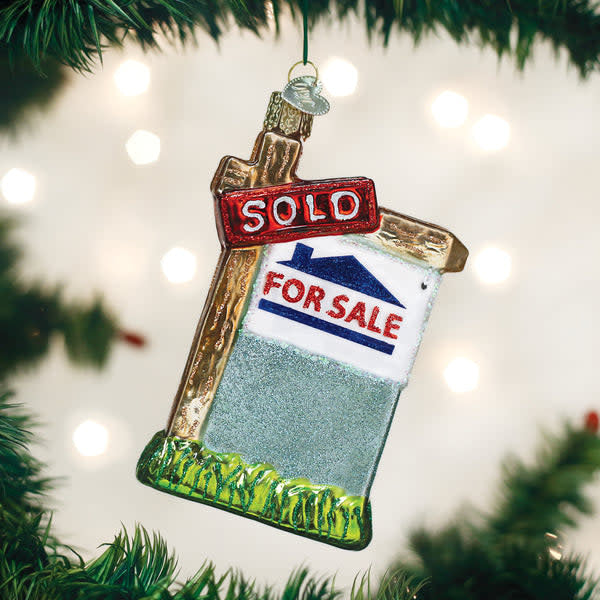 Mouth-blown glass ornament shaped like a 'Sold' realty sign with hand-painted details and glitter finish.