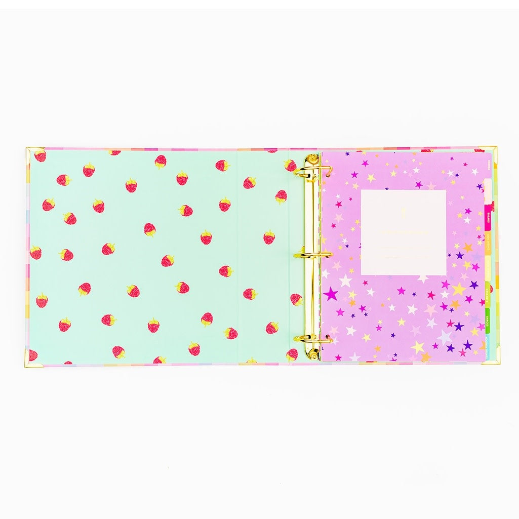 Gold-foiled recipe binder with eight colorful patterned tabs inside a three-ring system.