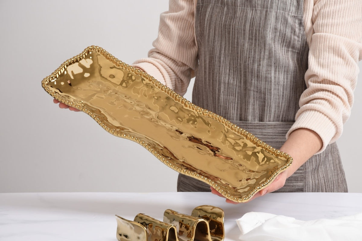 Rectangular gold-toned porcelain serving piece with lustrous gold beads from the Monaco Collection.