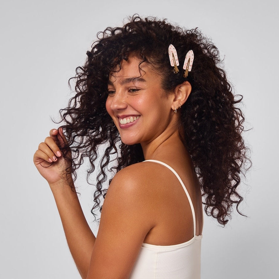 Four cherry-print recycled plastic creaseless hair clips arranged on a neutral background.