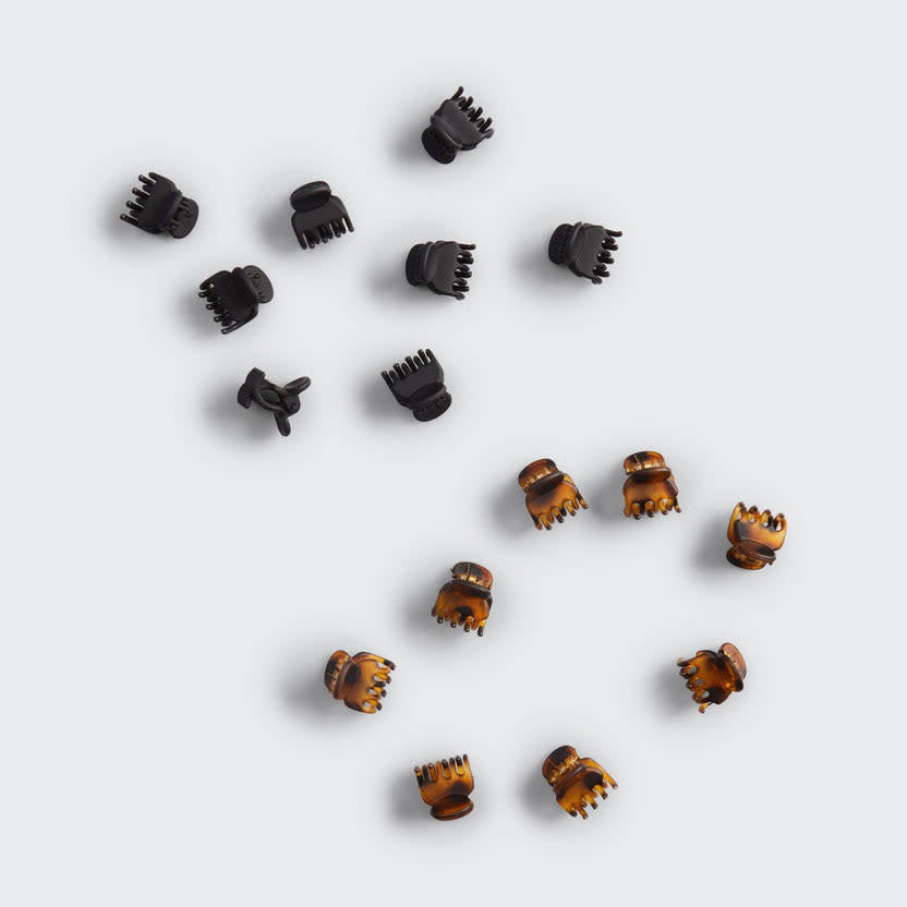 Set of sixteen small recycled plastic claw clips in a neutral tone.