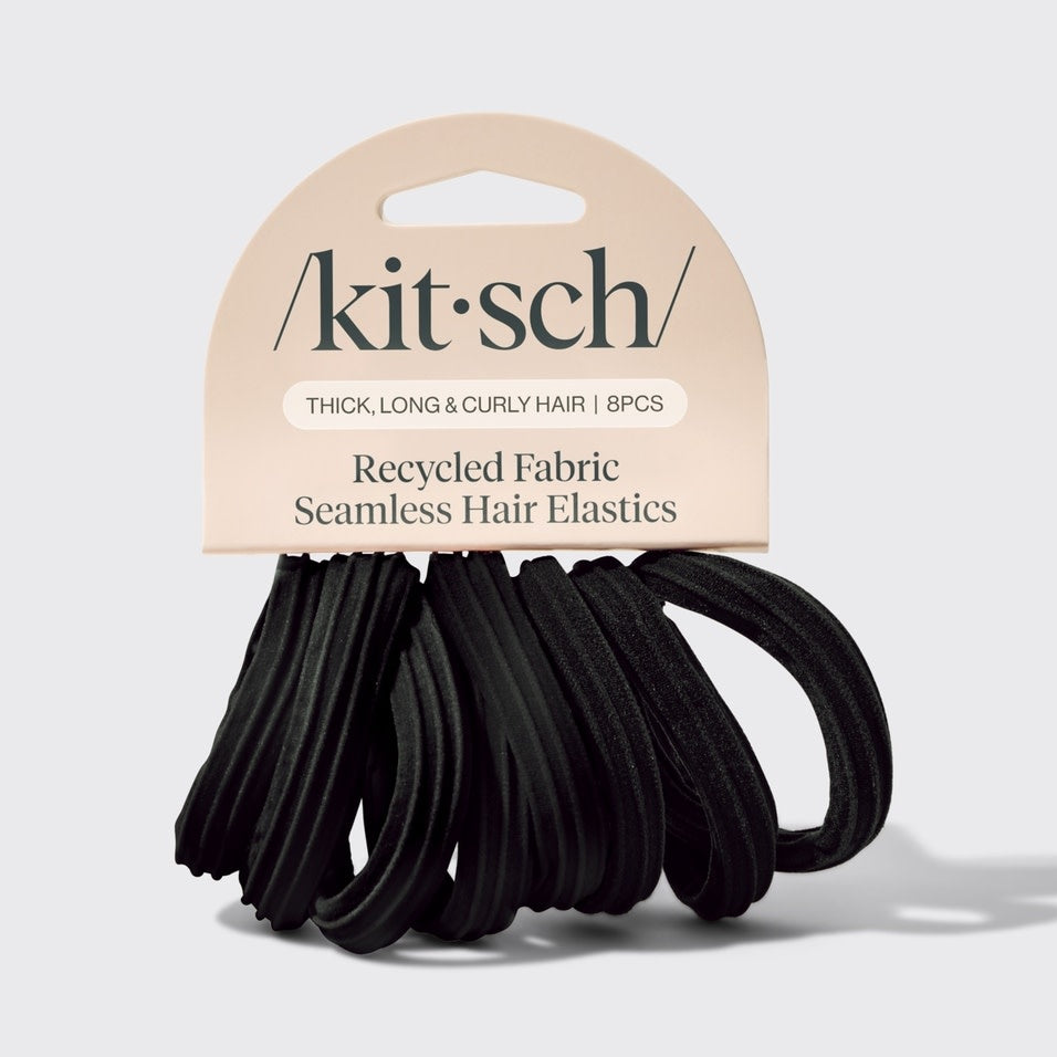 Set of eight black recycled seamless hair elastics in a clear packaging.
