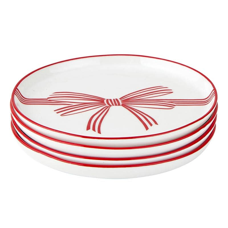 White ceramic appetizer plate with a whimsical red bow rim pattern
