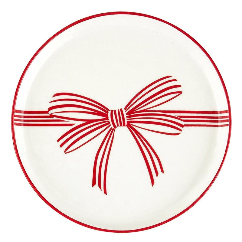 White ceramic appetizer plates with a whimsical red bow rim pattern
