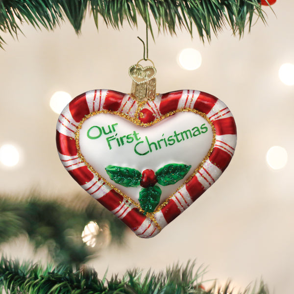 Red heart-shaped peppermint ornament with white polka dots on a silver wire hanger.