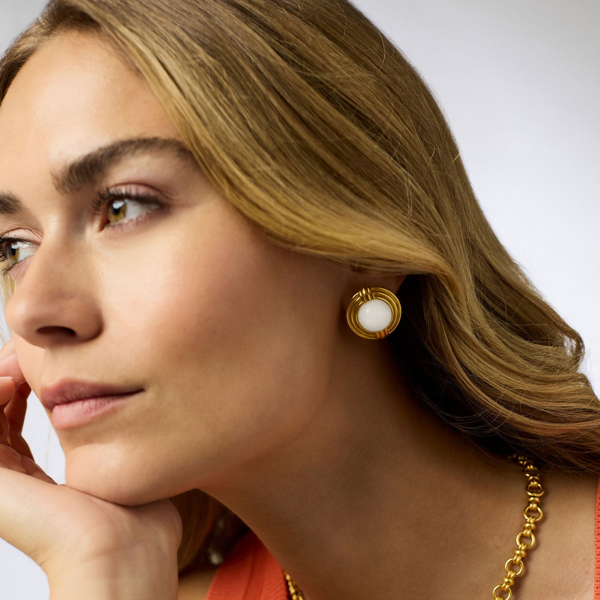 Gold-plated jade stud earring with a stone center.