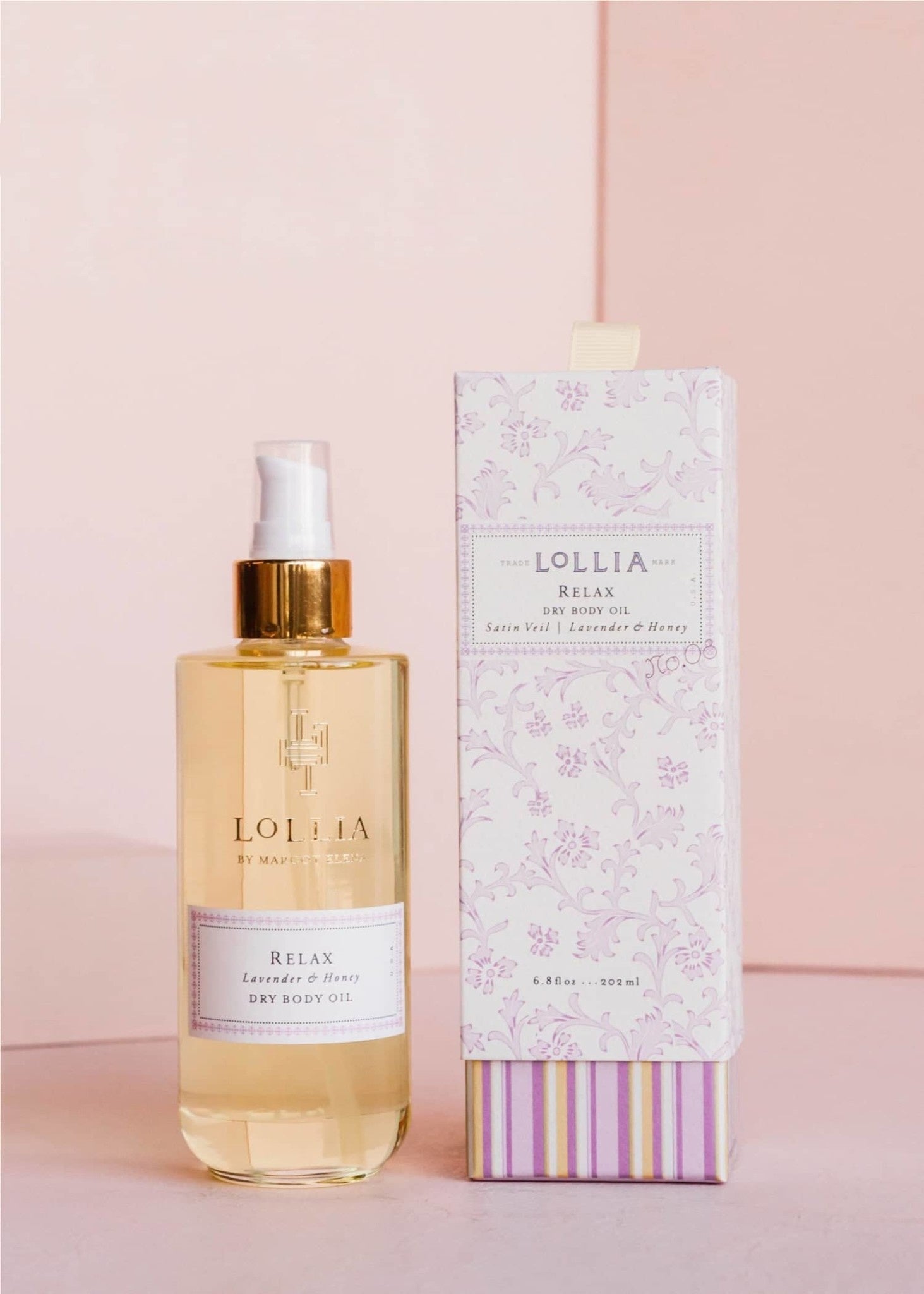 Gold-kissed glass bottle of Relax Dry Body Oil with lavender honey blossom fragrance in French floral box