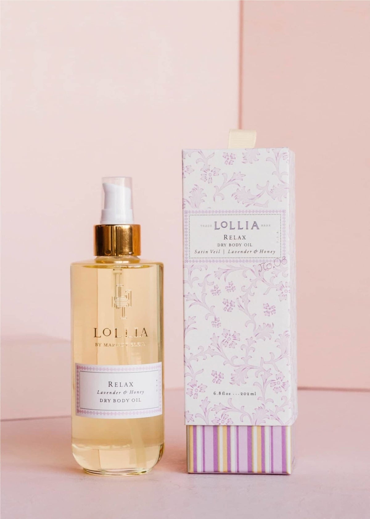 Gold-kissed glass bottle of Relax Dry Body Oil with lavender honey blossom fragrance in French floral box