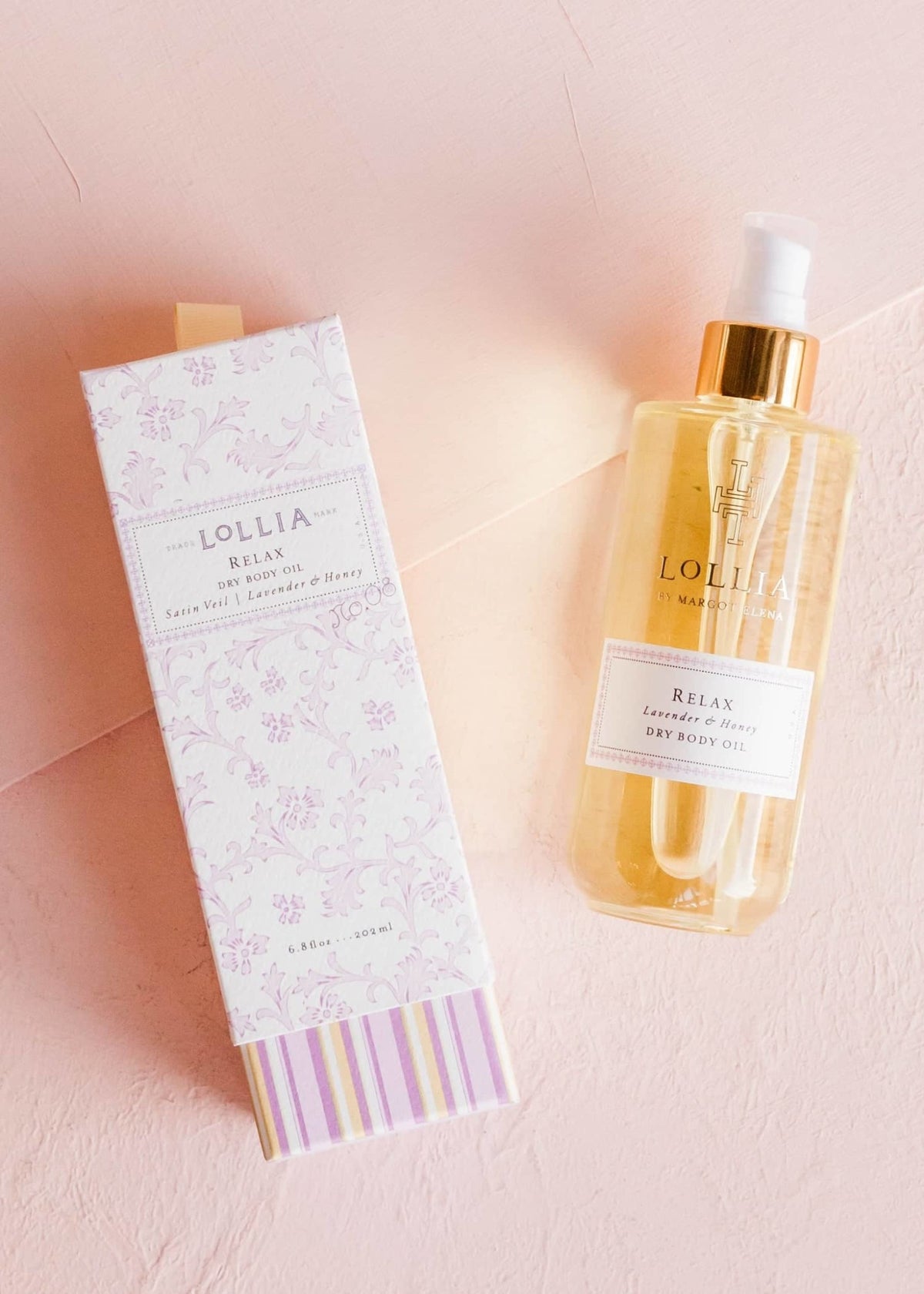 Gold-kissed glass bottle of Relax Dry Body Oil with lavender honey blossom fragrance