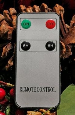 Black remote control with white buttons designed to operate an LED candle.