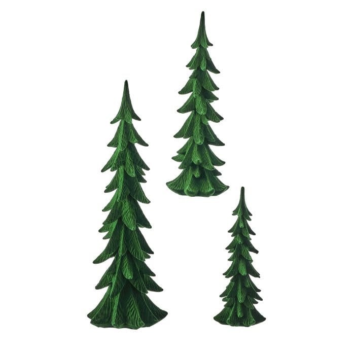 Small resin flocked tree with a realistic snow-dusted finish on a tabletop.