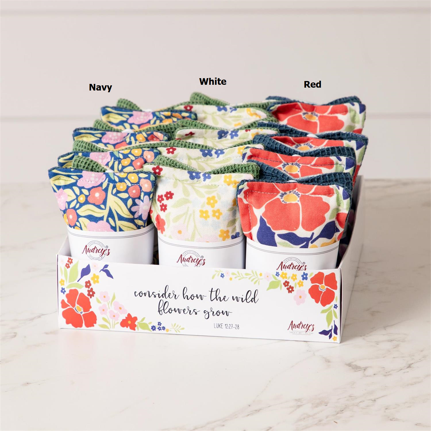 Three reusable cotton fabric sponges with a fun floral print pattern.