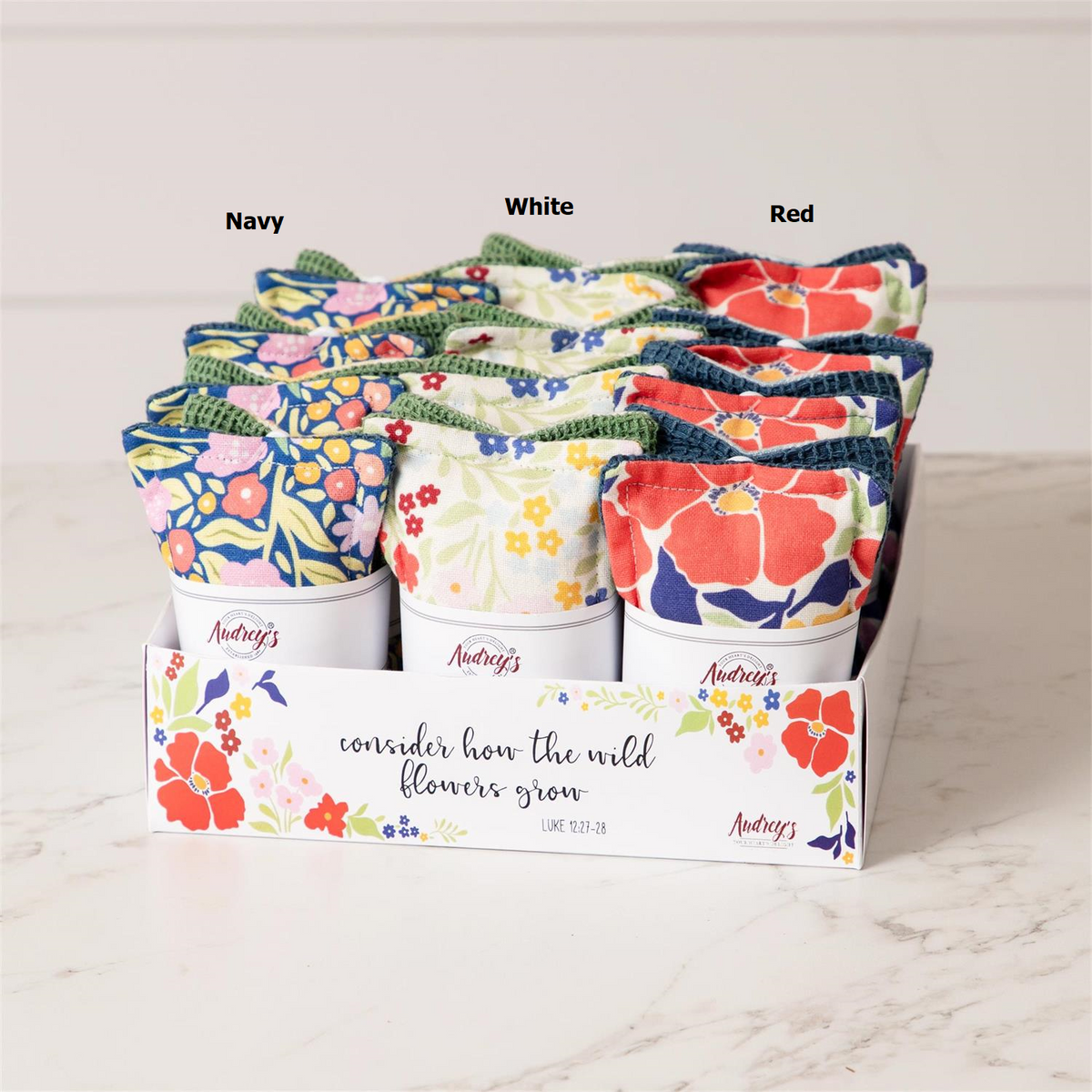 Set of reusable cotton fabric sponges with a fun floral pattern in pastel colors.