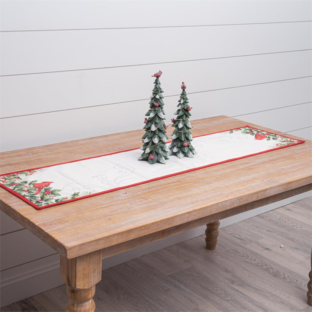 Reversible cotton table runner with cardinal and holly print on one side.