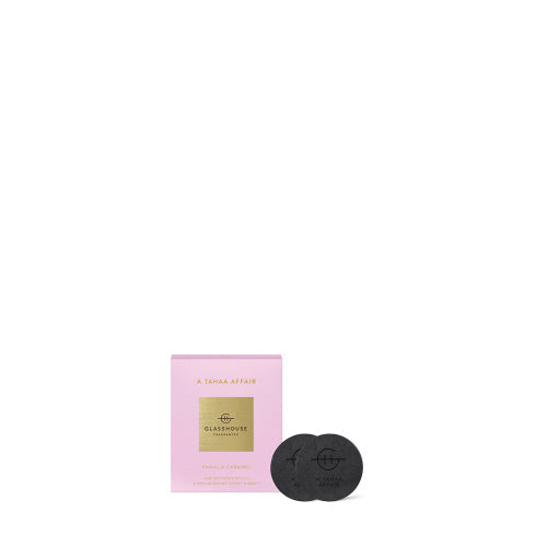 A Tahaa Affair car diffuser refill with a sleek black cylindrical body featuring white floral patterns.