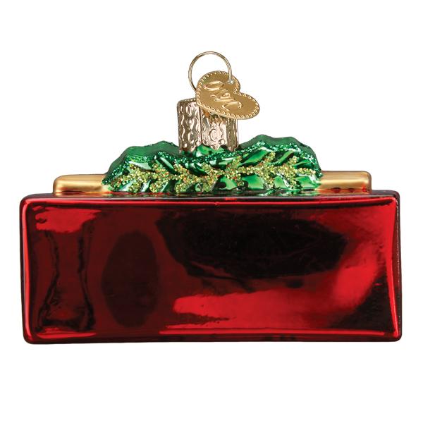 Joy ornament with a warm red finish featuring the word JOY in white lettering and gold accents.