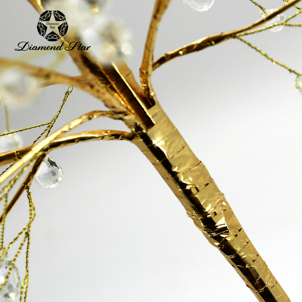 Close-up of a gold decorative Christmas tree trunk and branches with hanging clear crystals.
