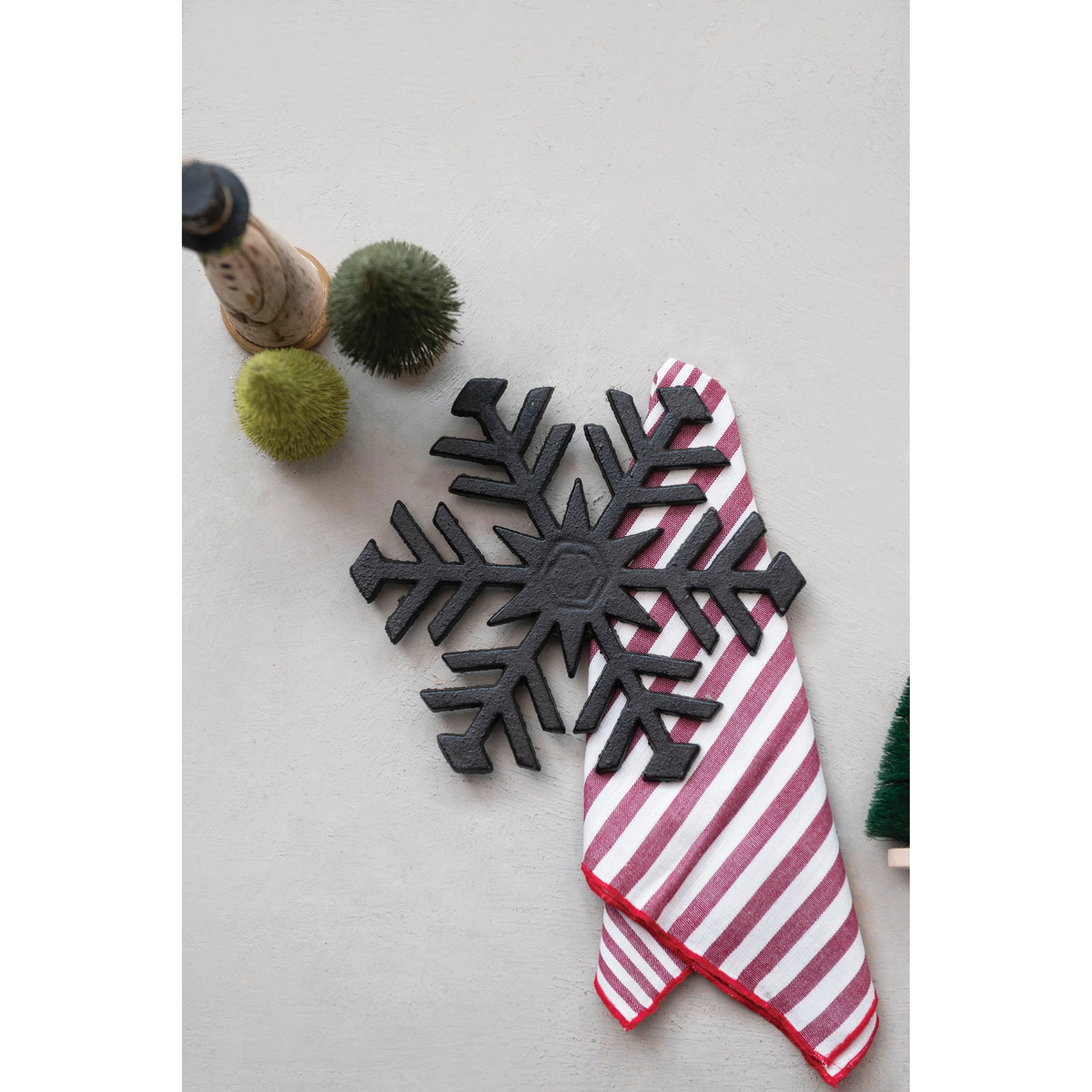 Cast iron snowflake trivet with intricate cutout patterns