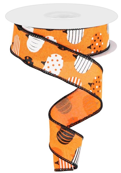 A roll of polyester ribbon featuring a repeating pumpkin print in orange and green tones.