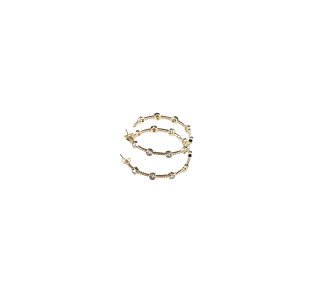 Gold Stargazer Station hoop earrings with round bezel-set crystals on a twisted metal band.