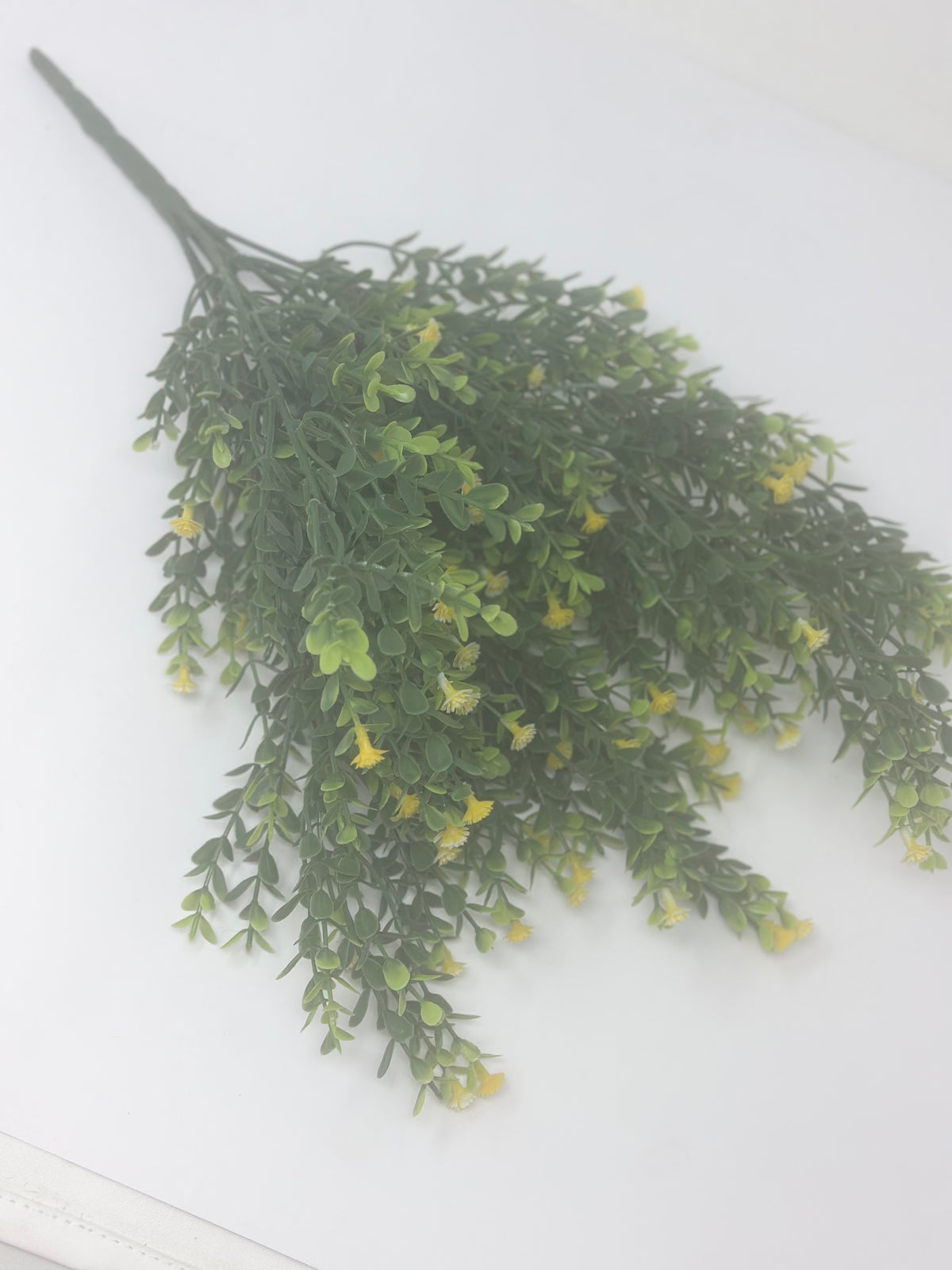Green artificial gypso bush with small yellow flowers, 19 inches tall.