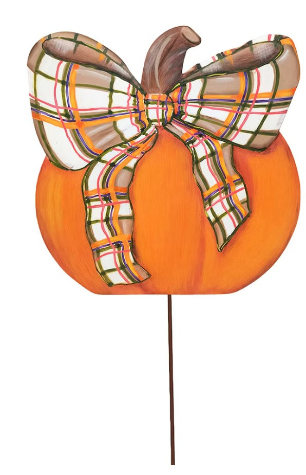 Orange pumpkin garden stake featuring a colorful plaid bow and a brown stem.