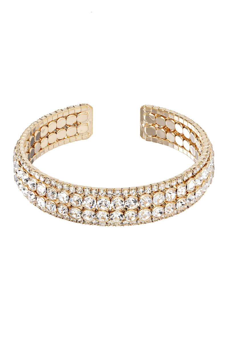 Open cuff bracelet with four lines of rhinestones in silver tone