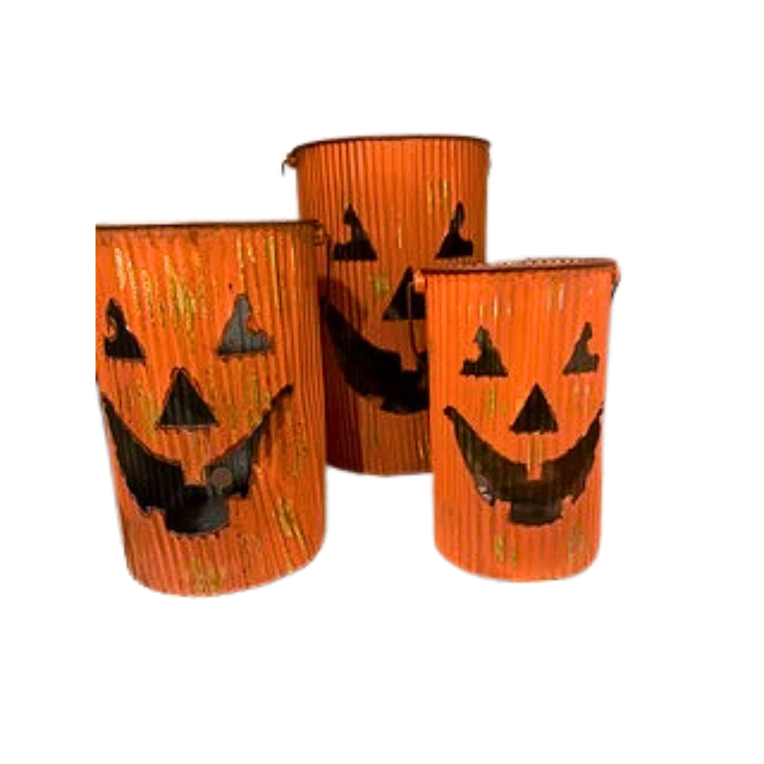 Set of three orange corrugated metal pumpkin lantern buckets with cutout jack-o'-lantern faces.